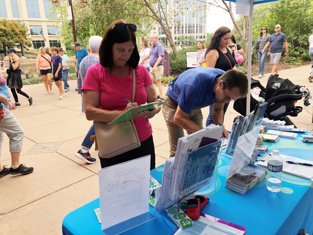 people talking at fair table