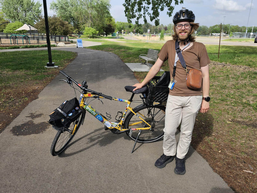 Man standing by his bike